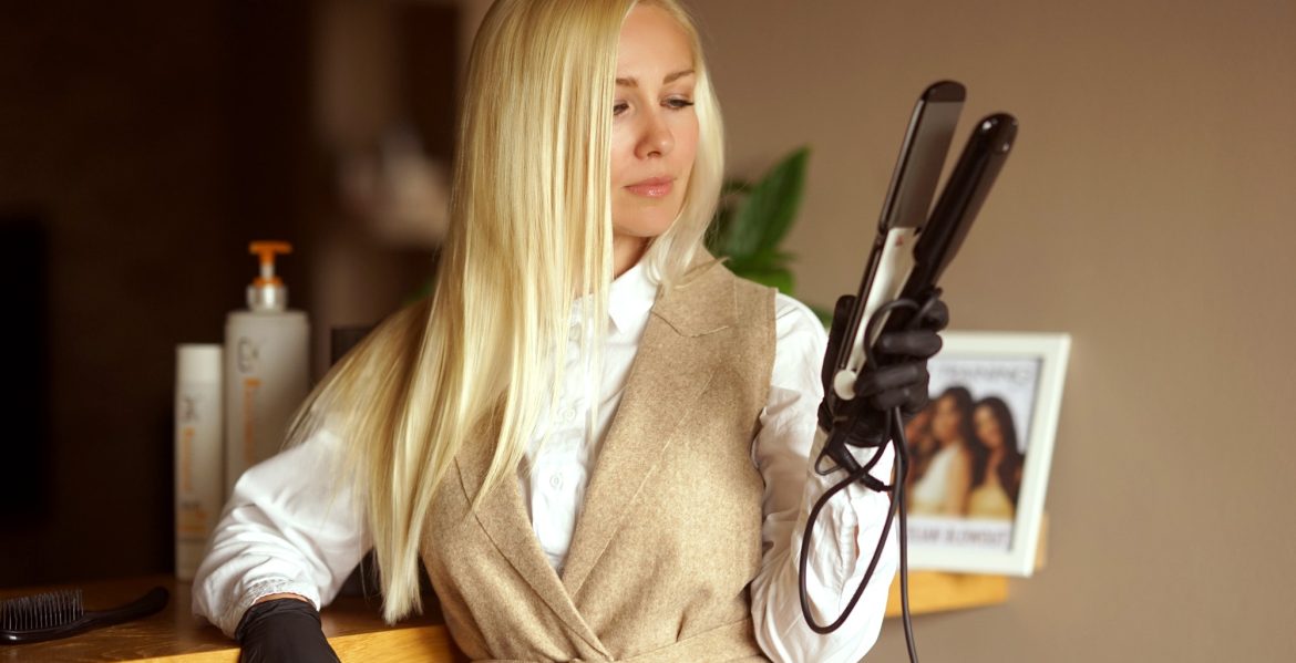 A blonde girl works as a hair stylist A blonde girl works as a hair stylist